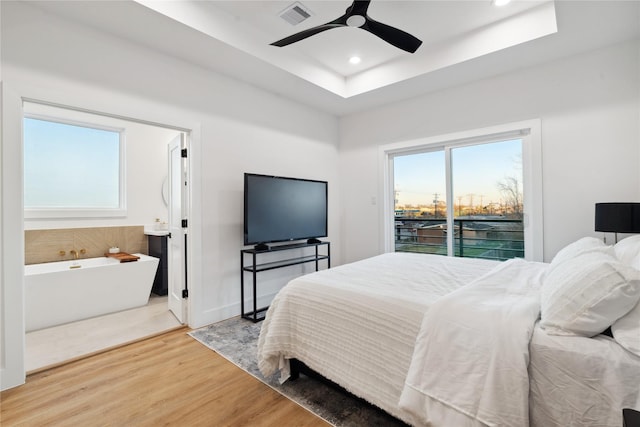 4323 Rogers St, Houston, TX 77022 - bedroom with access to outside, light wood-style floors, visible vents, recessed lighting, and a raised ceiling