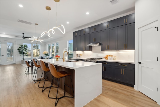 4323 Rogers St, Houston, TX 77022 - kitchen with recessed lighting, under cabinet range hood, visible vents, and light countertops