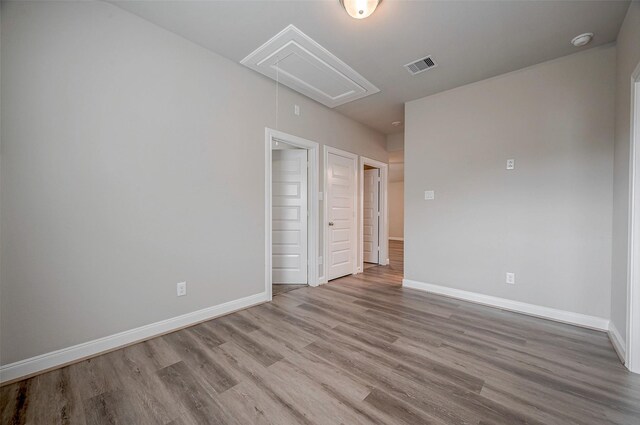 24603 Dover Bend Way, Richmond, TX 77406 - unfurnished bedroom featuring attic access, wood finished floors, and baseboards