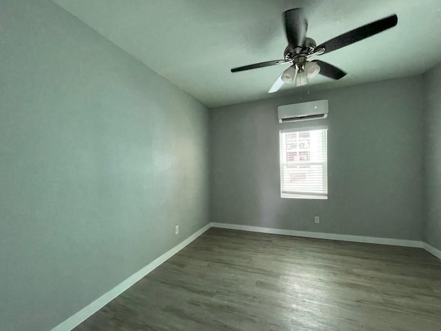1701 40th St, Galveston, TX 77550 - spare room featuring an AC wall unit, baseboards, wood finished floors, and ceiling fan