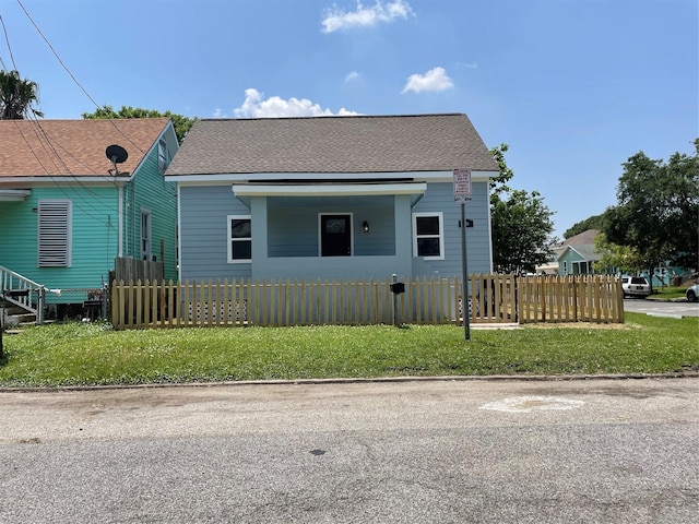 1701 40th St, Galveston, TX 77550 - bungalow-style home with a fenced front yard and roof with shingles