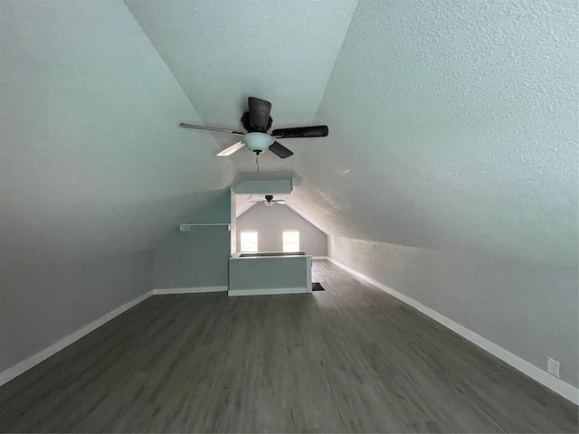 1701 40th St, Galveston, TX 77550 - bonus room with baseboards, vaulted ceiling, dark wood-style flooring, ceiling fan, and a textured ceiling