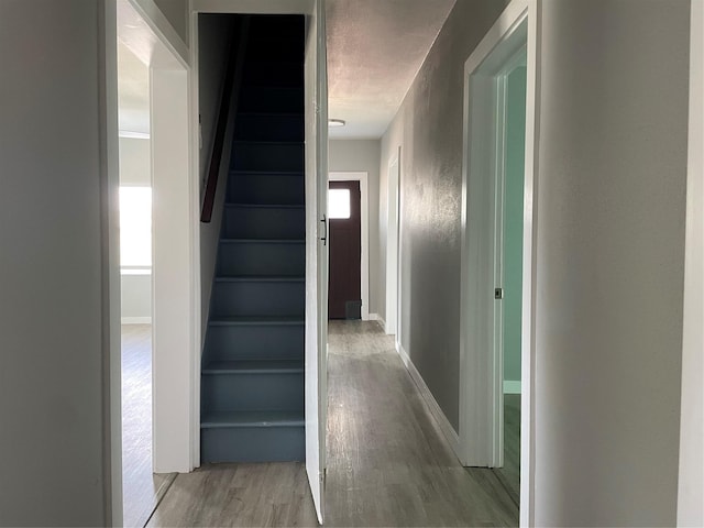 1701 40th St, Galveston, TX 77550 - stairs featuring wood finished floors, a textured ceiling, and baseboards