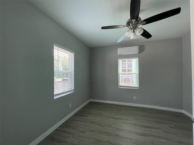 1701 40th St, Galveston, TX 77550 - spare room with an AC wall unit, plenty of natural light, baseboards, and dark wood-style floors