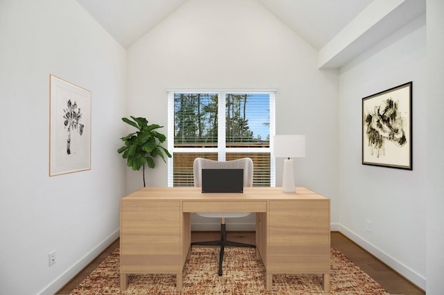 office area featuring wood finished floors, baseboards, and vaulted ceiling