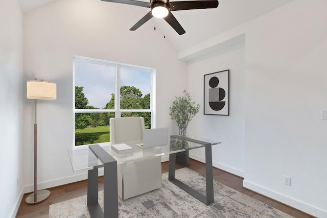 home office featuring baseboards, a ceiling fan, vaulted ceiling, and a wealth of natural light