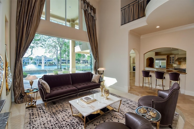 2 Royal Hampton Ct, Sugar Land, TX 77479 - living room with recessed lighting, a towering ceiling, arched walkways, crown molding, and baseboards