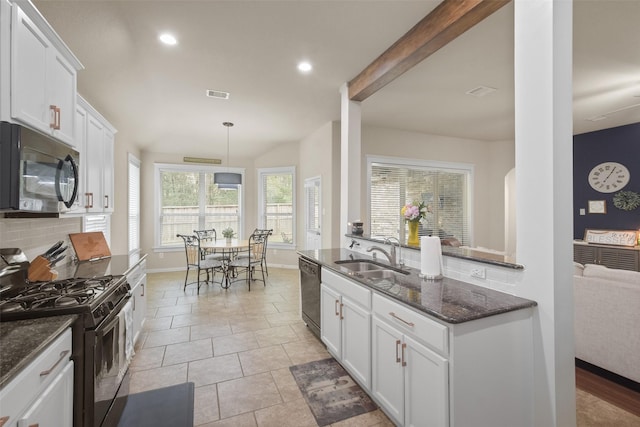 kitchen with dark stone countertops, visible vents, a sink, black appliances, and white cabinetry
