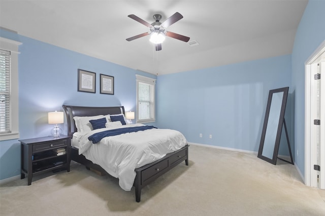 carpeted bedroom featuring visible vents, baseboards, and ceiling fan