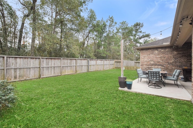 view of yard with a patio area and a fenced backyard