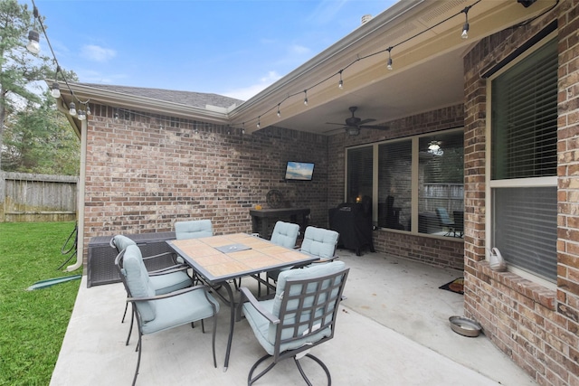 view of patio / terrace with fence, outdoor dining area, and a ceiling fan