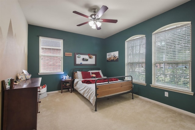 bedroom with carpet flooring, baseboards, and a ceiling fan