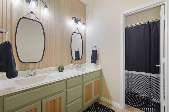 bathroom featuring tile patterned floors, double vanity, a sink, and baseboards