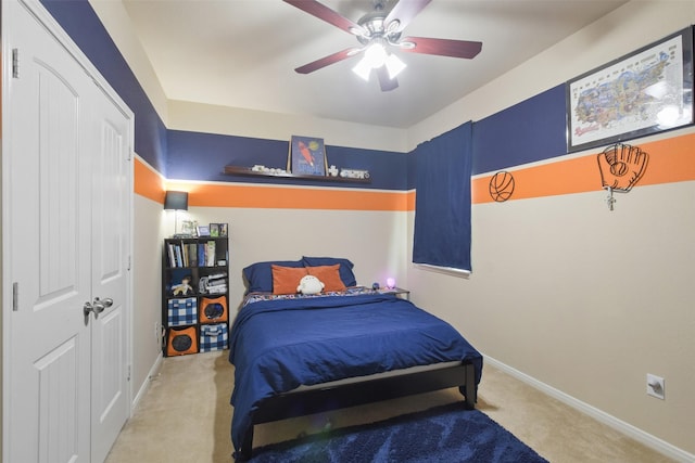 bedroom featuring ceiling fan, a closet, carpet flooring, and baseboards