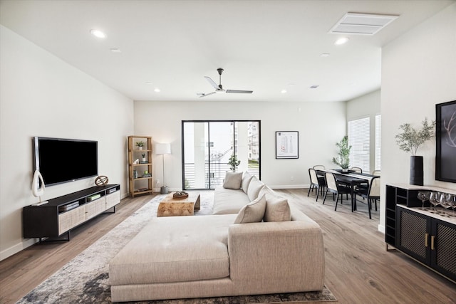 living area featuring baseboards, recessed lighting, visible vents, ceiling fan, and wood finished floors