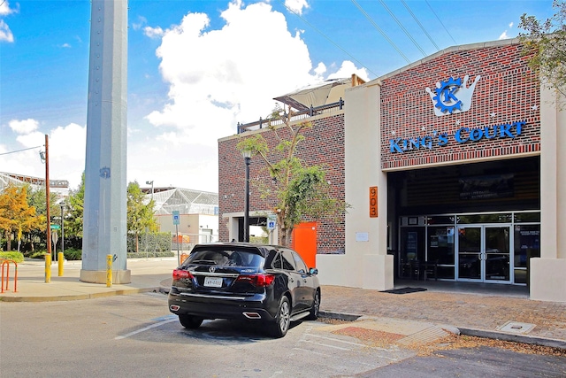 view of building exterior featuring uncovered parking