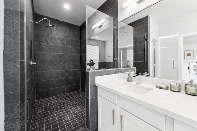 bathroom with a walk in shower and vanity