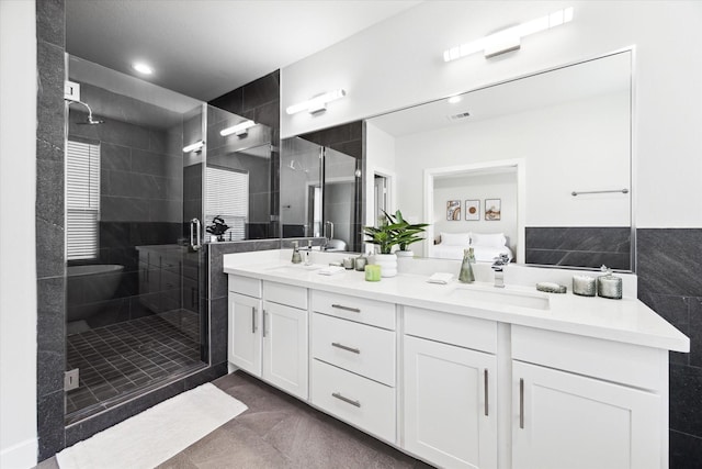 bathroom featuring visible vents, recessed lighting, a sink, a stall shower, and double vanity