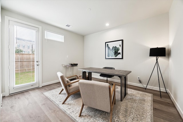 home office featuring visible vents, baseboards, recessed lighting, and wood finished floors