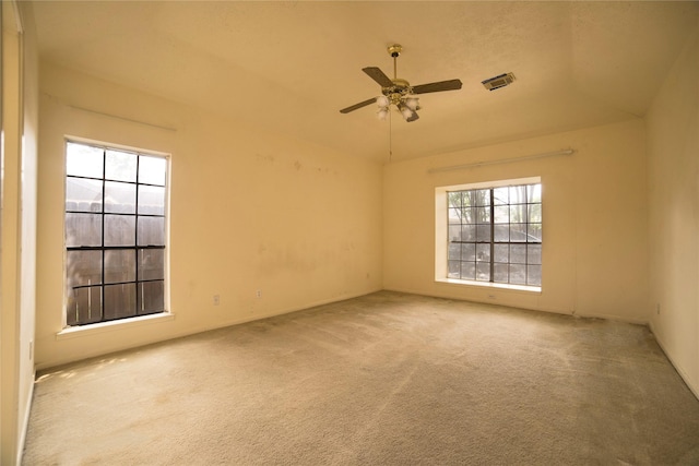 unfurnished room featuring ceiling fan, carpet flooring, and visible vents