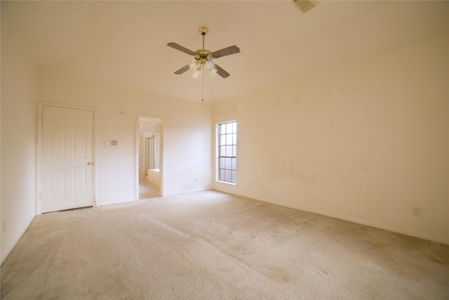 carpeted spare room with visible vents and ceiling fan
