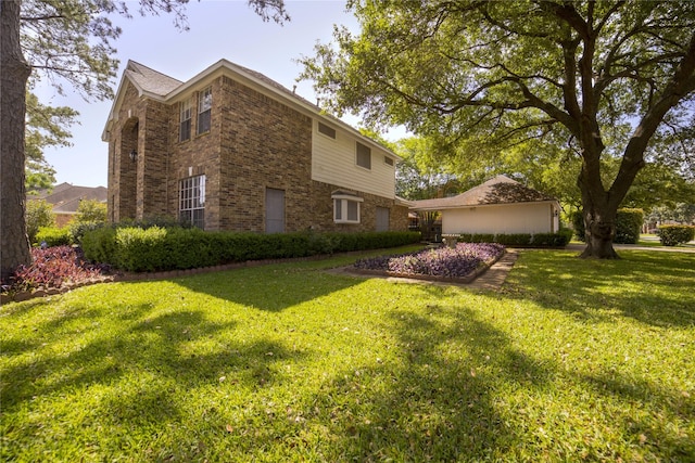 view of side of property with brick siding and a yard