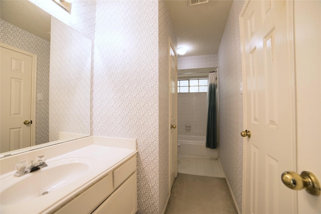 bathroom featuring wallpapered walls, visible vents, vanity, and bathing tub / shower combination