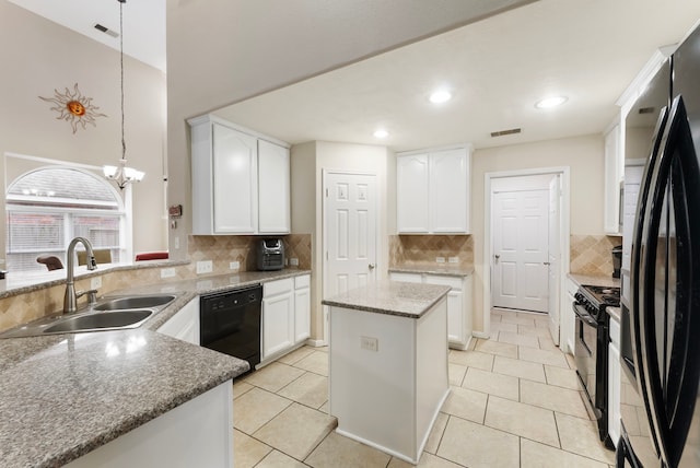 8322 Calico Canyon Dr, Tomball, TX 77375 - kitchen with black appliances, a sink, tasteful backsplash, white cabinetry, and light stone countertops