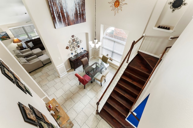 8322 Calico Canyon Dr, Tomball, TX 77375 - stairway featuring tile patterned flooring, baseboards, and a towering ceiling