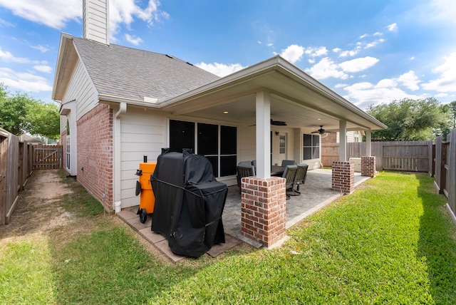 8322 Calico Canyon Dr, Tomball, TX 77375 - rear view of house featuring brick siding, roof with shingles, a ceiling fan, a patio area, and a chimney