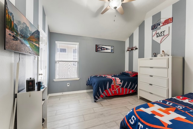 8322 Calico Canyon Dr, Tomball, TX 77375 - bedroom featuring vaulted ceiling, wood finished floors, a ceiling fan, and baseboards