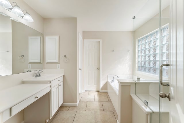 8322 Calico Canyon Dr, Tomball, TX 77375 - bathroom with a garden tub, vanity, baseboards, tile patterned floors, and a shower with door