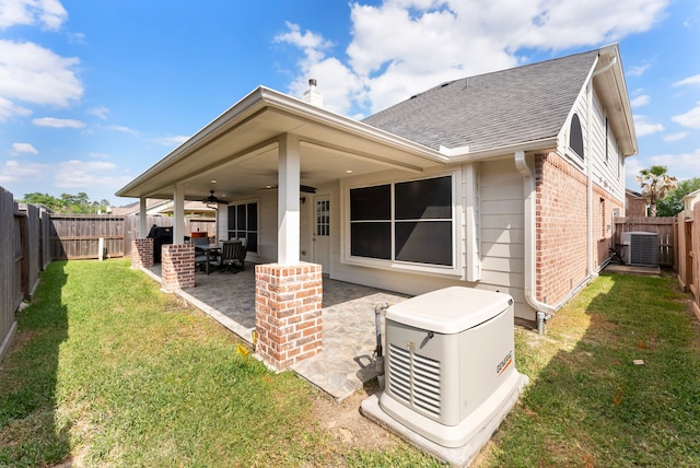 8322 Calico Canyon Dr, Tomball, TX 77375 - back of property with a ceiling fan, brick siding, roof with shingles, central AC unit, and a patio