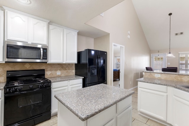 8322 Calico Canyon Dr, Tomball, TX 77375 - kitchen with black appliances, backsplash, light tile patterned floors, white cabinetry, and high vaulted ceiling