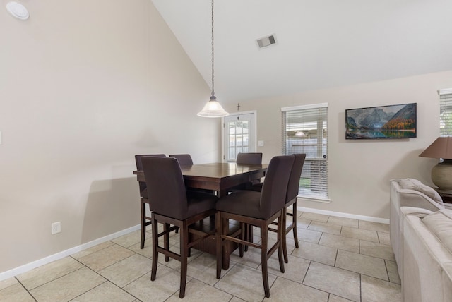 8322 Calico Canyon Dr, Tomball, TX 77375 - dining area with baseboards, high vaulted ceiling, and light tile patterned floors
