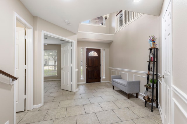 8322 Calico Canyon Dr, Tomball, TX 77375 - foyer entrance with plenty of natural light, light tile patterned flooring, and wainscoting