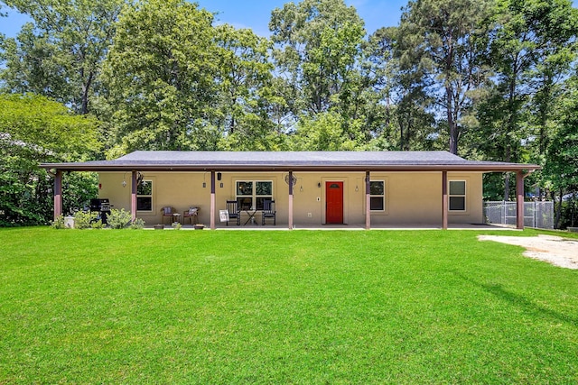 310 Hidden Oaks Dr, Point Blank, TX 77364 - back of house with stucco siding, fence, a yard, and a patio