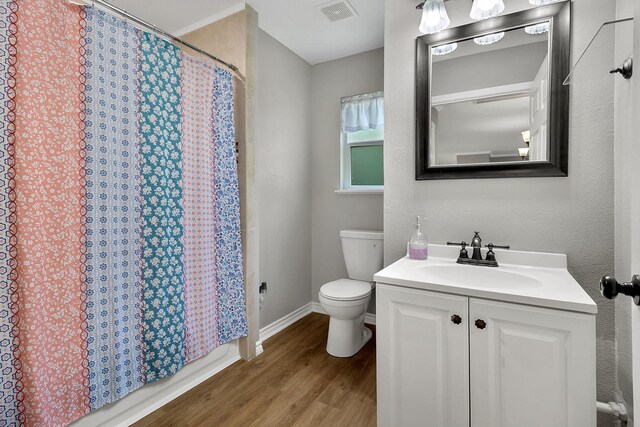 310 Hidden Oaks Dr, Point Blank, TX 77364 - bathroom with toilet, visible vents, baseboards, wood finished floors, and vanity