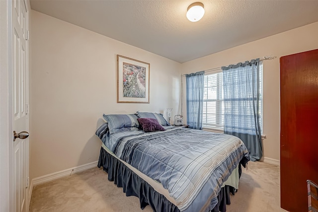 bedroom featuring light colored carpet and baseboards