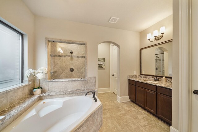 3225 Summer Tanager Ln, Manvel, TX 77578 - bathroom featuring plenty of natural light, a garden tub, vanity, and tiled shower