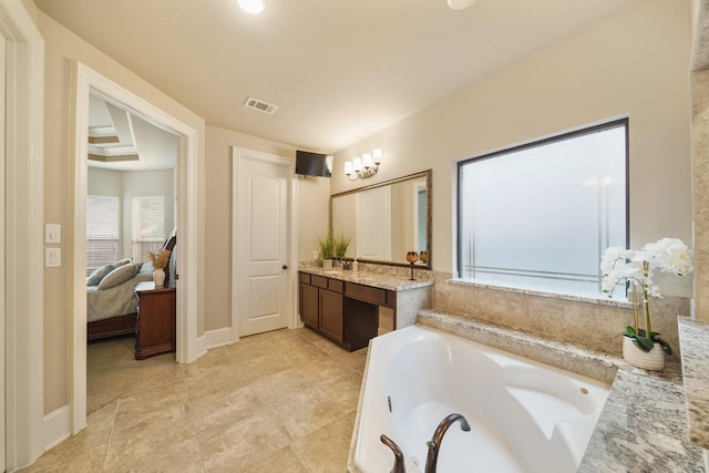 3225 Summer Tanager Ln, Manvel, TX 77578 - bathroom featuring a garden tub, vanity, connected bathroom, and baseboards