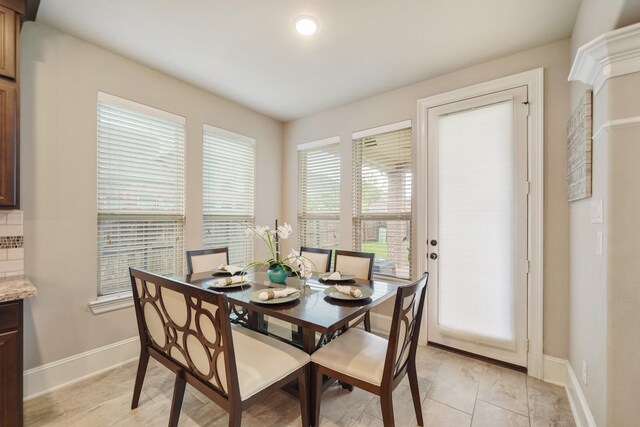 3225 Summer Tanager Ln, Manvel, TX 77578 - dining room with baseboards and light tile patterned flooring