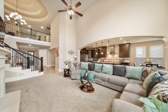 3225 Summer Tanager Ln, Manvel, TX 77578 - living area featuring arched walkways, a towering ceiling, light carpet, a chandelier, and ceiling fan