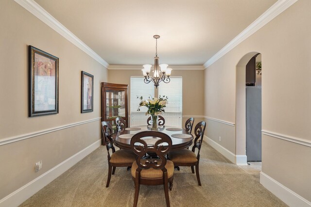 3225 Summer Tanager Ln, Manvel, TX 77578 - dining room with light carpet, crown molding, arched walkways, baseboards, and a chandelier