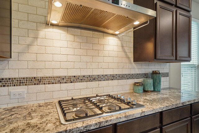 3225 Summer Tanager Ln, Manvel, TX 77578 - kitchen with extractor fan, stainless steel gas cooktop, and dark brown cabinets