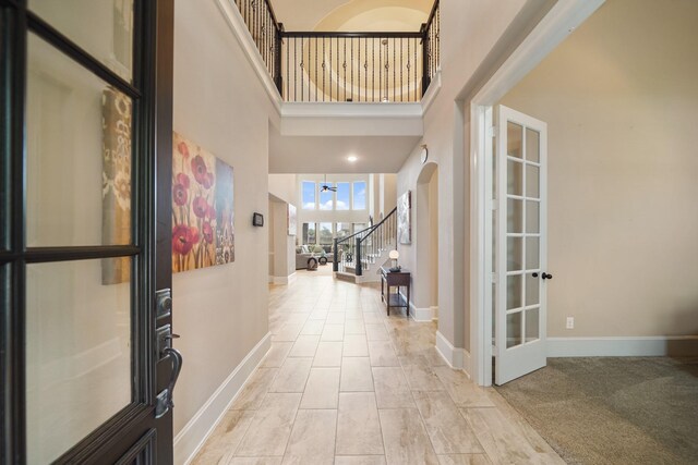 3225 Summer Tanager Ln, Manvel, TX 77578 - entrance foyer with stairs, baseboards, and a towering ceiling