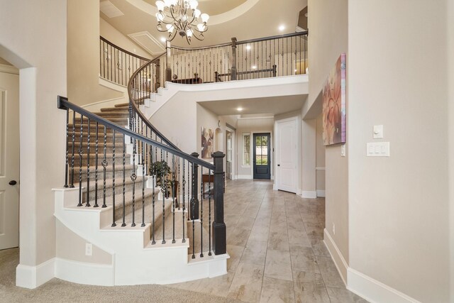 3225 Summer Tanager Ln, Manvel, TX 77578 - entrance foyer featuring a high ceiling, a chandelier, baseboards, and stairs