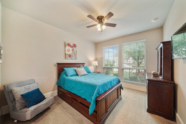 3225 Summer Tanager Ln, Manvel, TX 77578 - bedroom featuring light carpet, baseboards, and ceiling fan