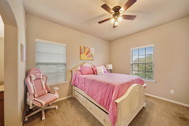 3225 Summer Tanager Ln, Manvel, TX 77578 - bedroom with light carpet, baseboards, and a ceiling fan