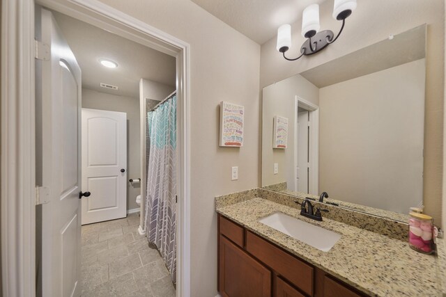 3225 Summer Tanager Ln, Manvel, TX 77578 - full bath featuring vanity, toilet, curtained shower, baseboards, and stone finish flooring